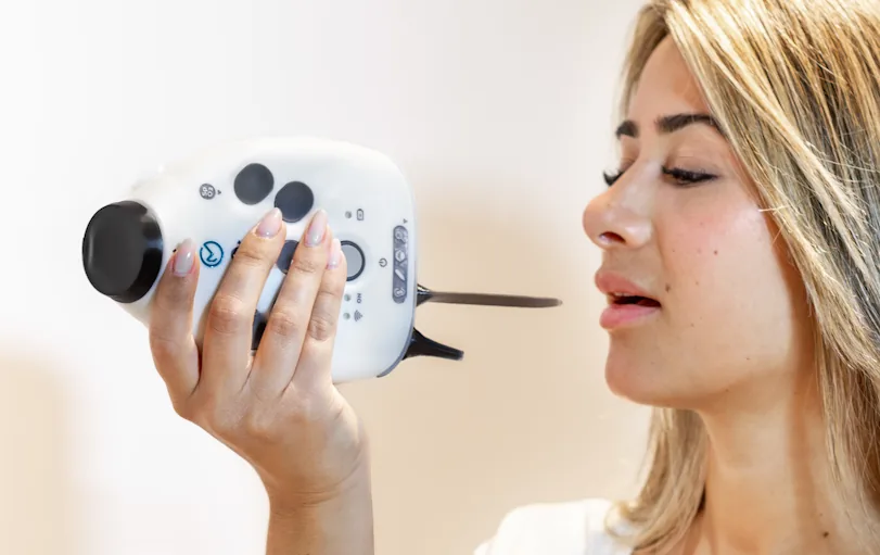 A person using the OmbuMed throat camera attachment